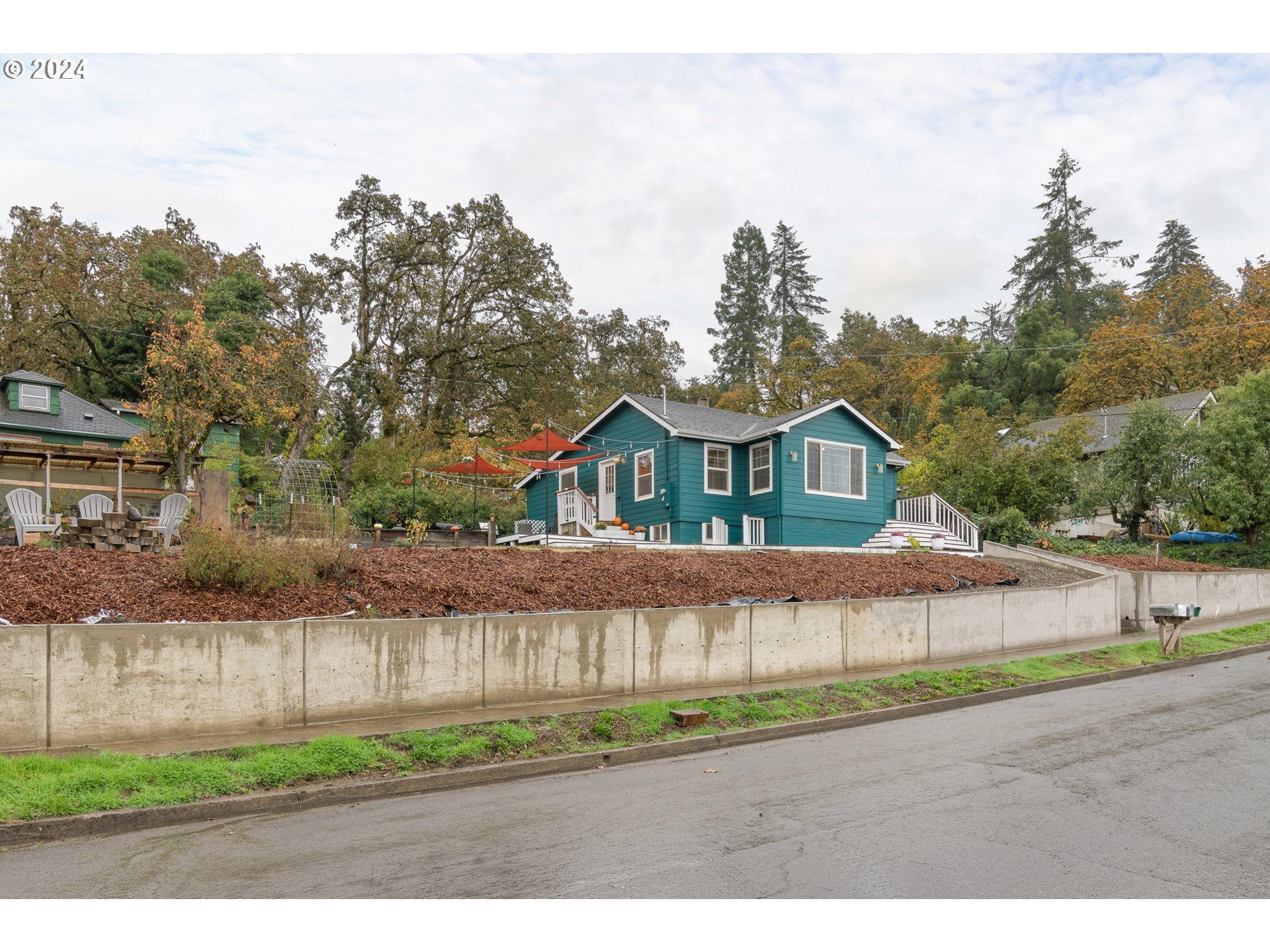 517 South 3rd Street Springfield, OR 97477 - Photo 23 of 27 a front view of a house with a yard and potted plants