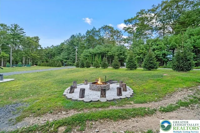 a backyard of a house with table and chairs
