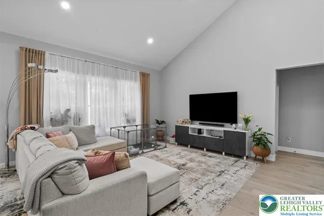 a kitchen with a dining table chairs and refrigerator