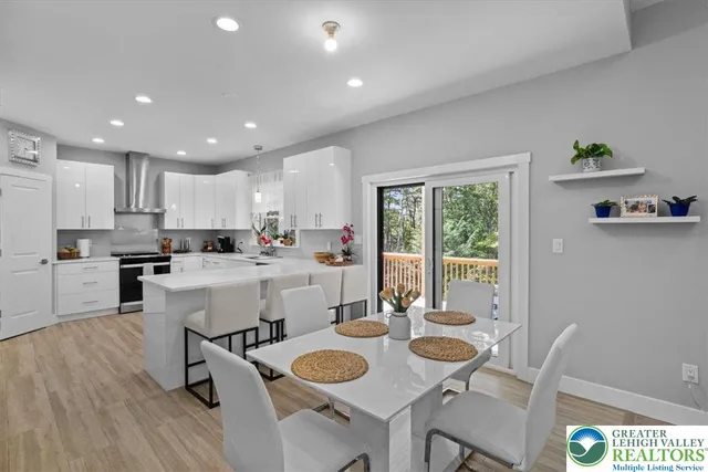 a large kitchen with kitchen island a sink stainless steel appliances and cabinets