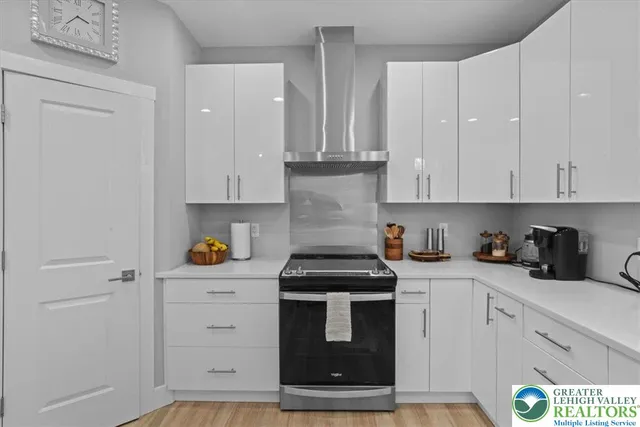 a kitchen with white cabinets and white appliances