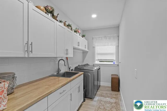 a bedroom with a bed and a flat tv screen on the dresser