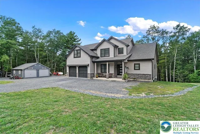 a front view of a house with a yard and porch