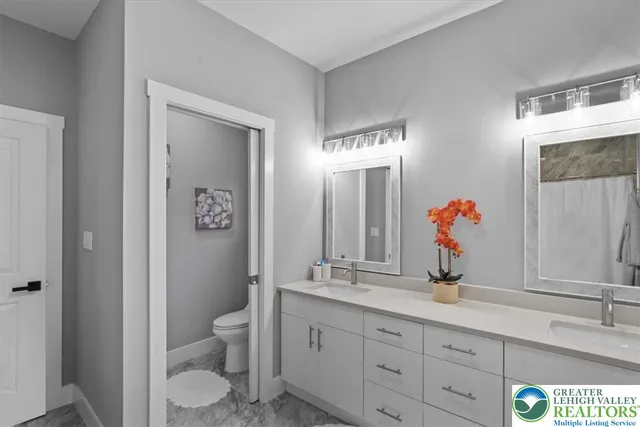 a bathroom with a sink vanity granite and a mirror