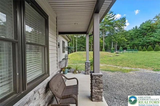 a view of a backyard with floor to ceiling window and wooden floor