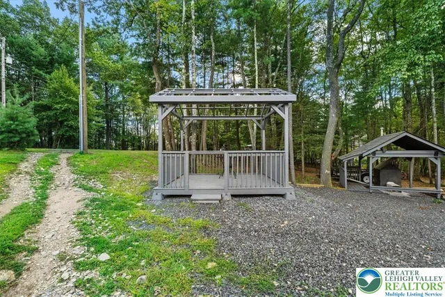a view of a chair and table in the garden