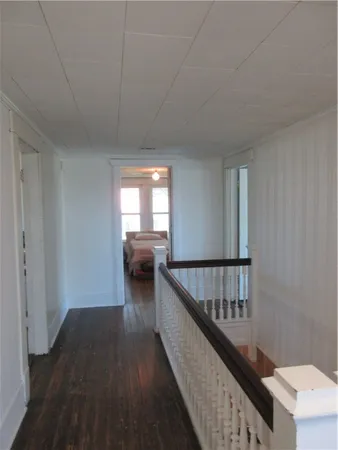 a way to room with wooden floor and stairs