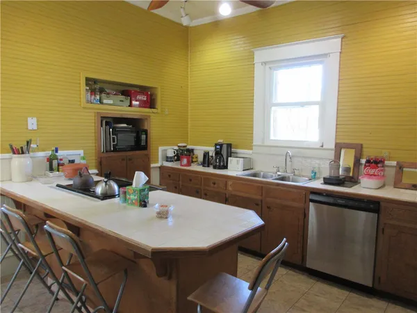a kitchen with a sink cabinets and window
