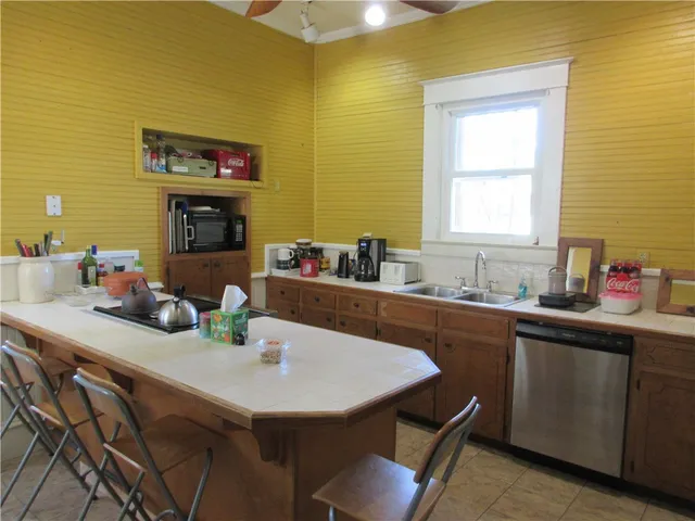 a kitchen with a sink cabinets and window