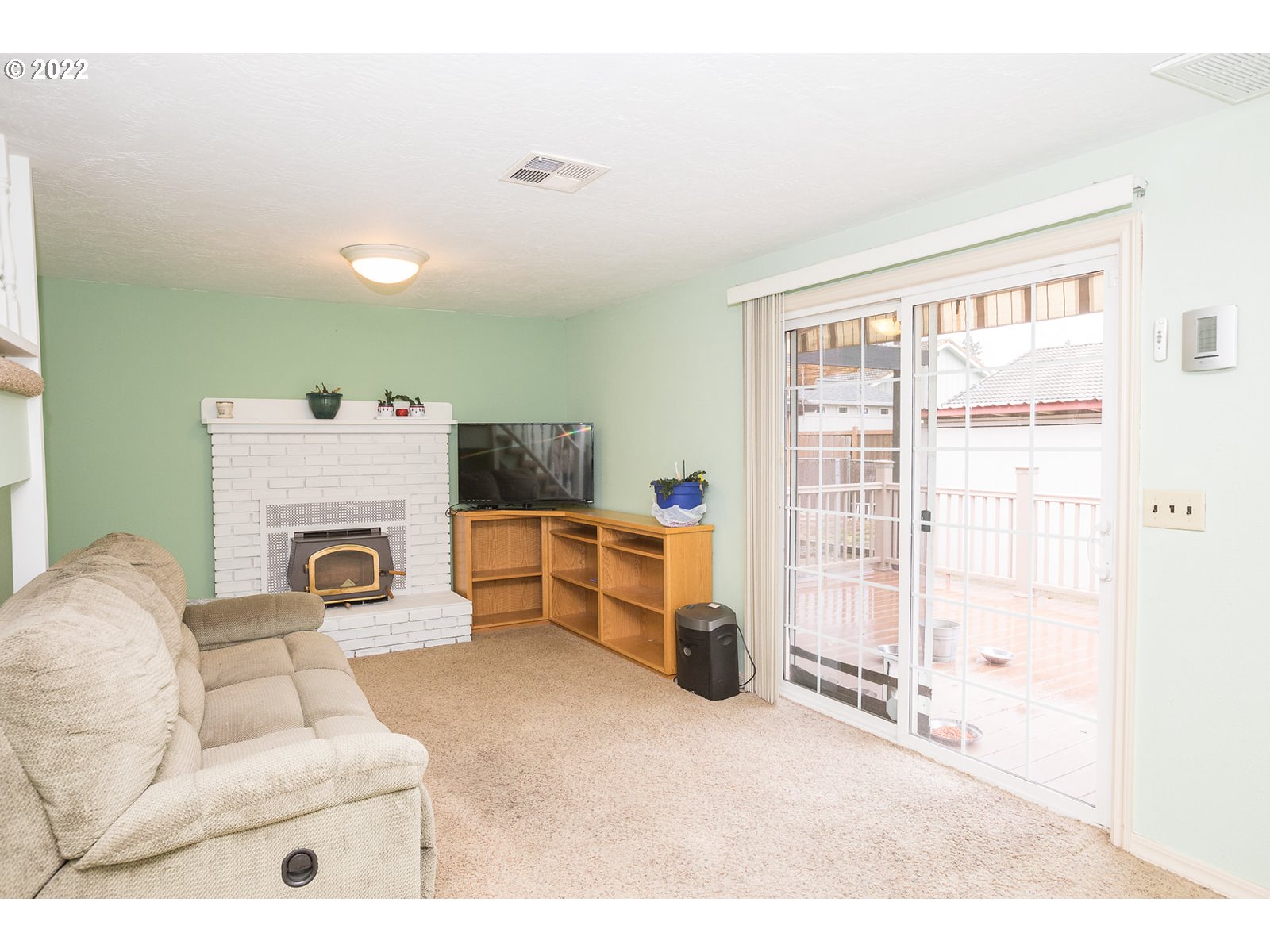753 Rowan Avenue Springfield, OR 97477 - Photo 17 of 30 a living room with furniture a flat screen tv and a fireplace