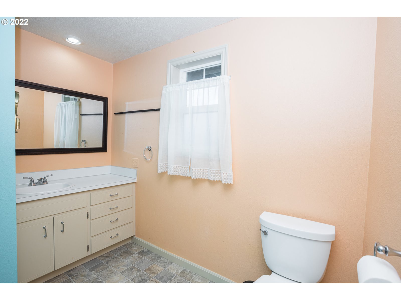 753 Rowan Avenue Springfield, OR 97477 - Photo 22 of 30 a bathroom with a toilet a sink a mirror and a window