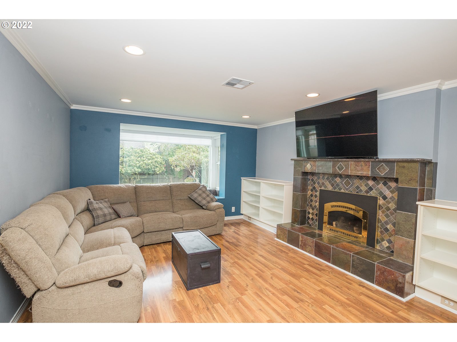 753 Rowan Avenue Springfield, OR 97477 - Photo 3 of 30 a living room with furniture a flat screen tv and a fireplace