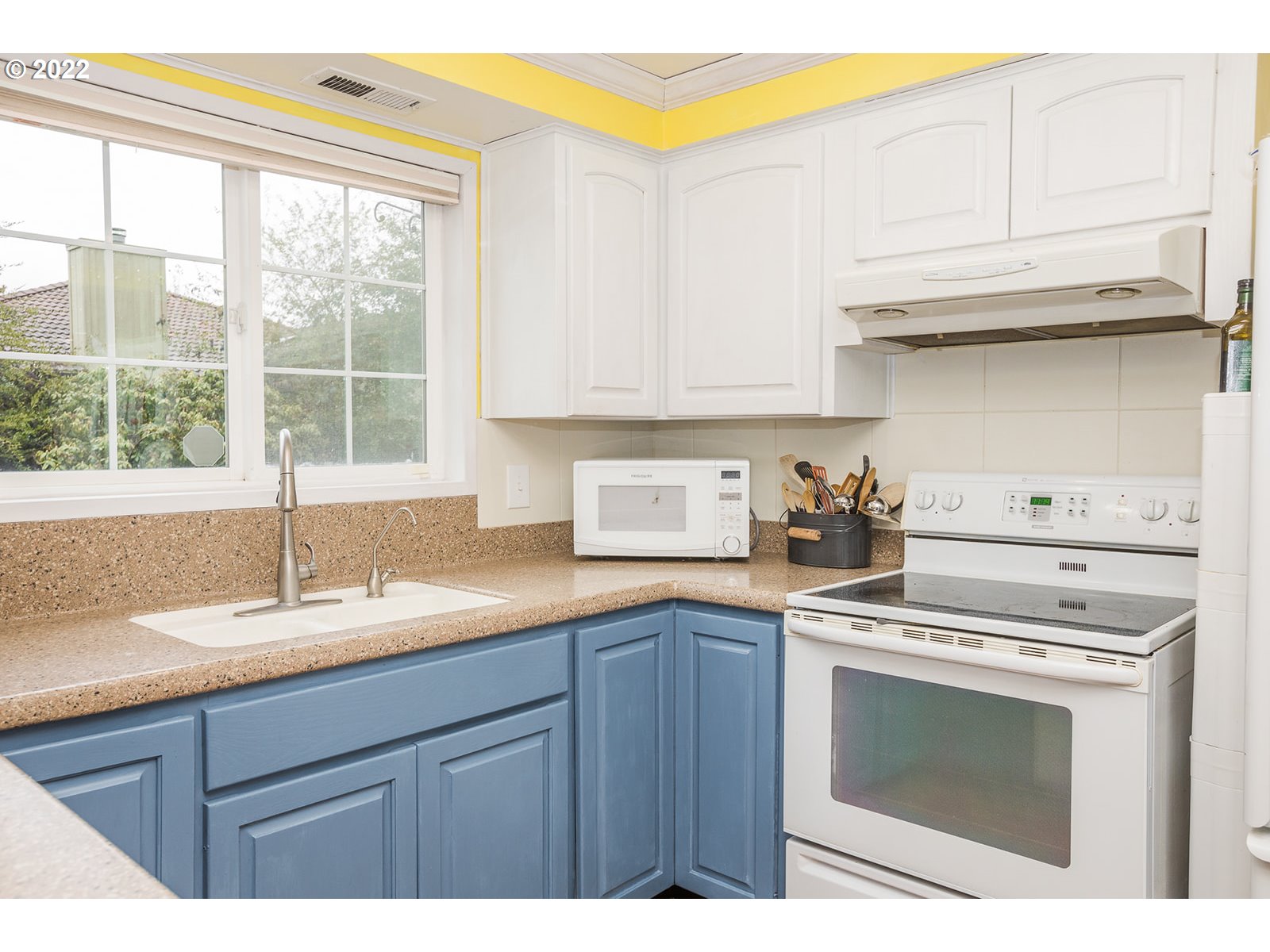 753 Rowan Avenue Springfield, OR 97477 - Photo 8 of 30 a kitchen with stainless steel appliances granite countertop a sink a stove and a microwave