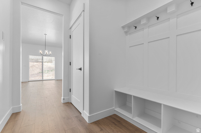 1341 West 2350 South, Unit 10 Perry, UT 84302 - Photo 9 of 18 Entryway with built-in bench and cubbies, featuring a paneled wall with coat hooks