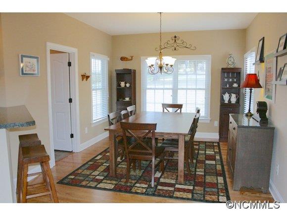 241 Hunters Trace Rutherfordton, NC 28139 - Photo 11 of 24 a dining room with furniture a chandelier and wooden floor