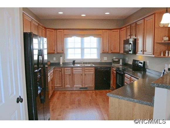 241 Hunters Trace Rutherfordton, NC 28139 - Photo 12 of 24 a kitchen with stainless steel appliances granite countertop a refrigerator a sink a stove and oven