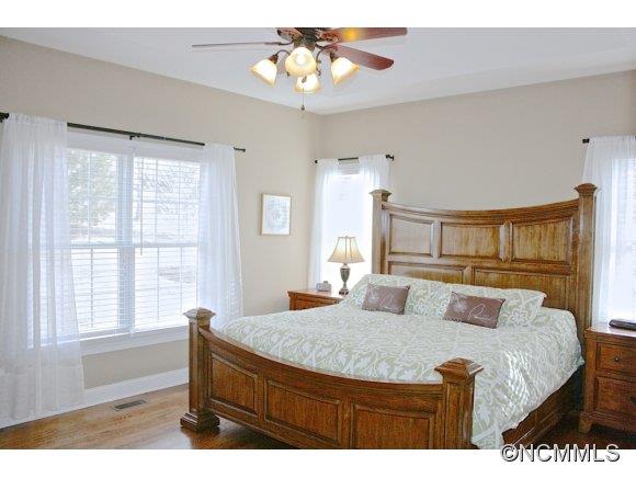 241 Hunters Trace Rutherfordton, NC 28139 - Photo 16 of 24 a bedroom with a bed and wooden floor