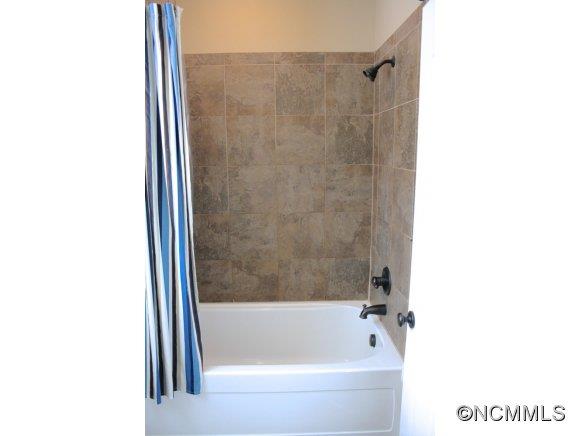 241 Hunters Trace Rutherfordton, NC 28139 - Photo 18 of 24 a bathroom with a bathtub and a shower