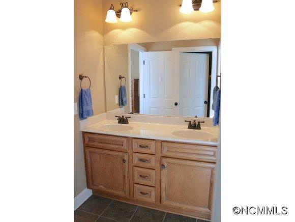 241 Hunters Trace Rutherfordton, NC 28139 - Photo 19 of 24 a bathroom with a sink and a mirror