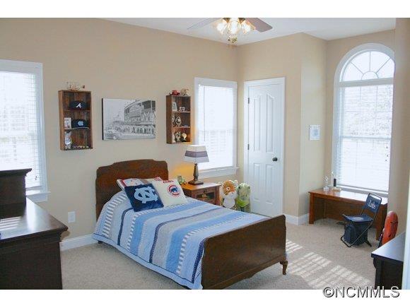241 Hunters Trace Rutherfordton, NC 28139 - Photo 21 of 24 a bedroom with a bed and a chandelier