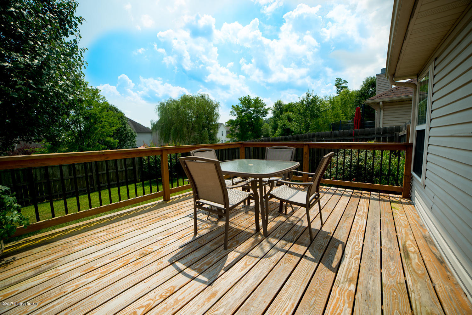 17520 Curry Branch Road Louisville, KY 40245 - Photo 32 of 45 Your outdoor oasis awaits! A spacious back deck with rod iron railing spans much of the rear of the home and could easily accommodate a large outdoor dining table, a grill, lounge chairs, and accent furniture