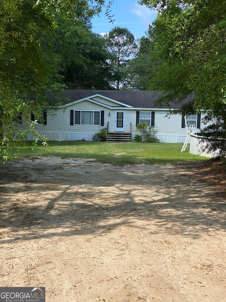 391 Reedy Creek Circle Lyons, GA 30436 - Photo 1 of 1 a front view of a house with a yard