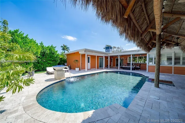 swimming pool view with a garden space