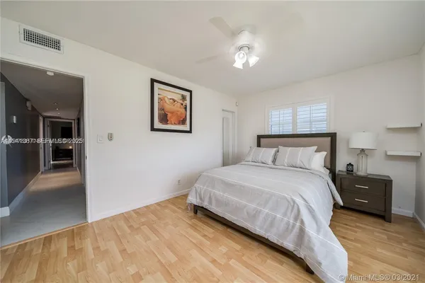 a bedroom with a bed and a view of kitchen