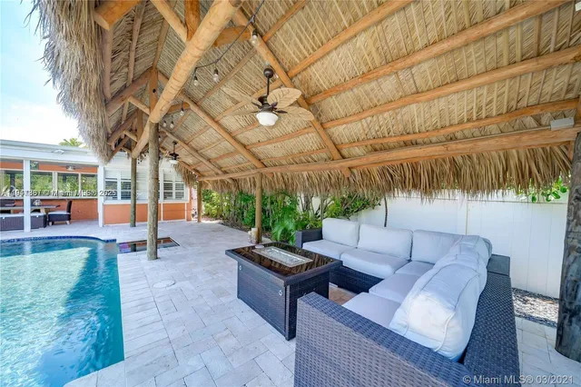 a outdoor living space with furniture and umbrella