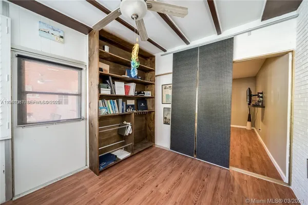 a work room with wooden floor and furniture