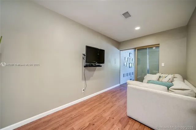 a living room with furniture a table and chairs next to a window