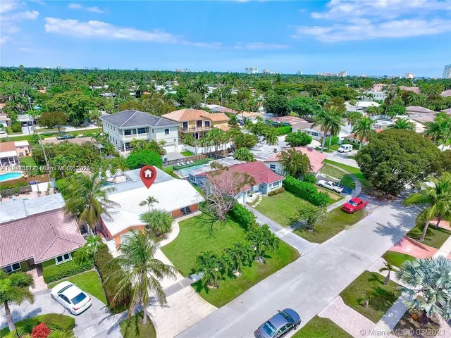 an aerial view of multiple houses with yard
