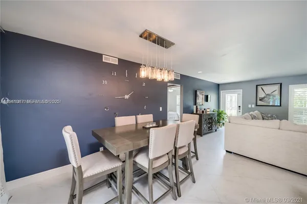 a view of a dining room with furniture and window