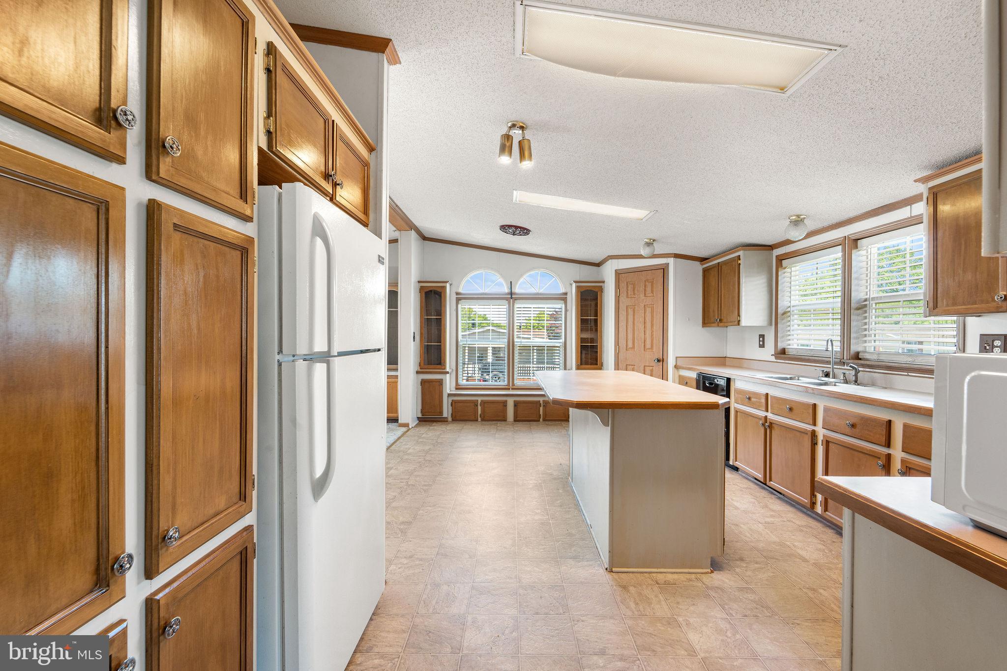 402 Ford Hook Road Doylestown, PA 18901 - Photo 16 of 26 a kitchen with stainless steel appliances granite countertop a refrigerator a sink dishwasher a stove and a dining table with wooden floor