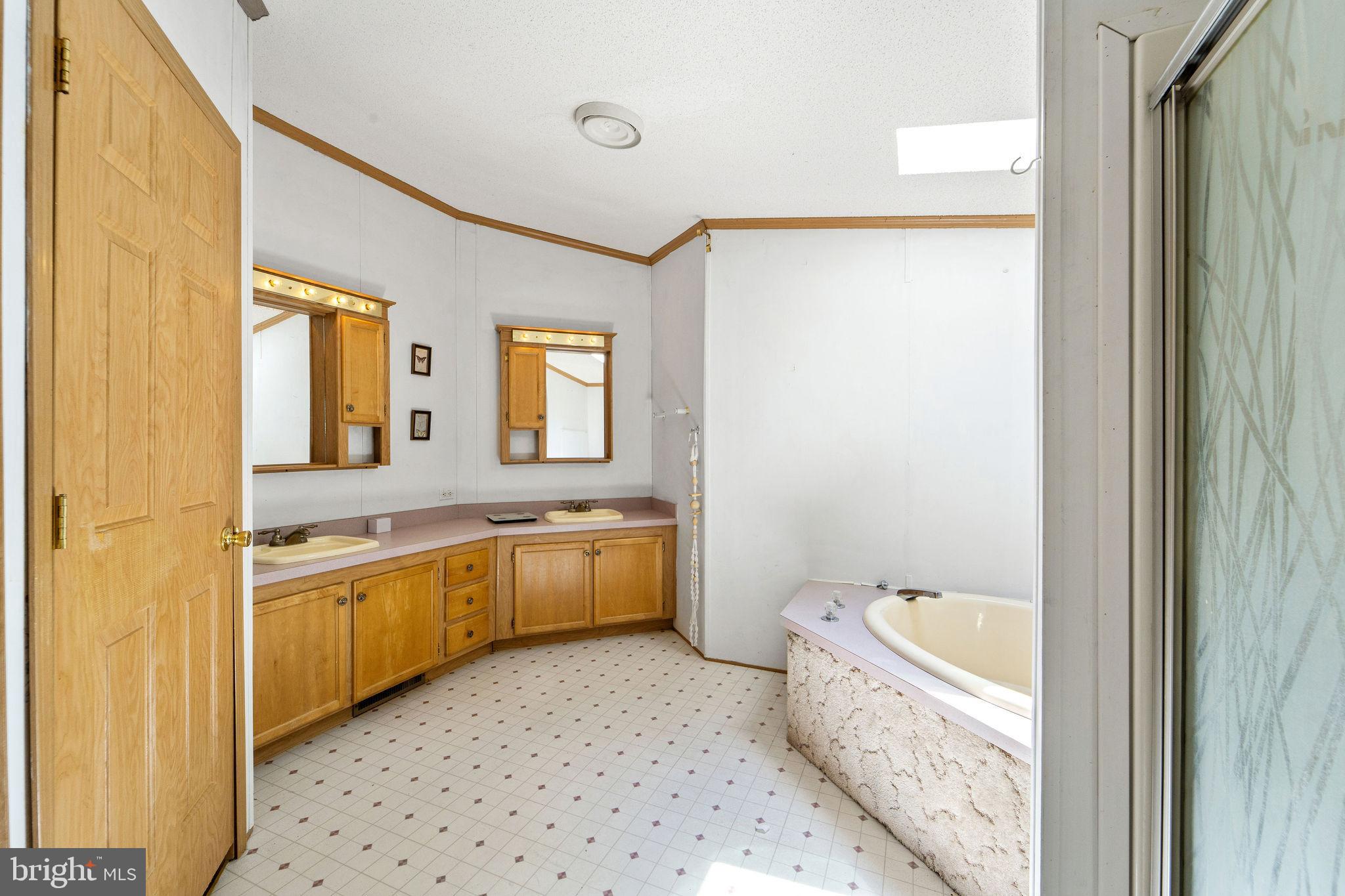402 Ford Hook Road Doylestown, PA 18901 - Photo 24 of 26 a bathroom with a granite countertop sink and a bathtub