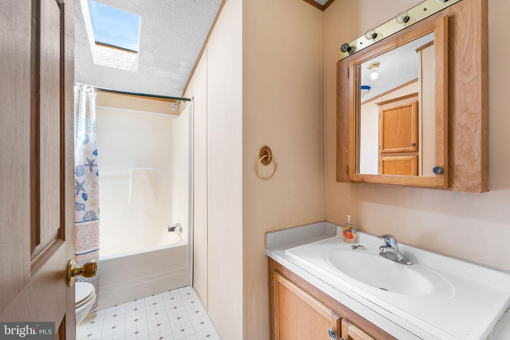 402 Ford Hook Road Doylestown, PA 18901 - Photo 9 of 26 a bathroom with a sink a mirror and a shower