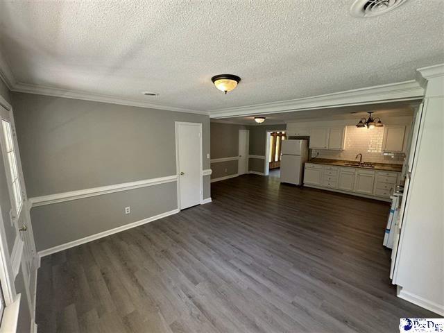 1057 Sam Lee Road Scranton, SC 29591 - Photo 15 of 23 Unfurnished living room featuring a textured ceili