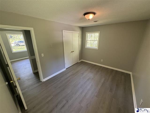 1057 Sam Lee Road Scranton, SC 29591 - Photo 16 of 23 Unfurnished bedroom with a textured ceiling, a clo