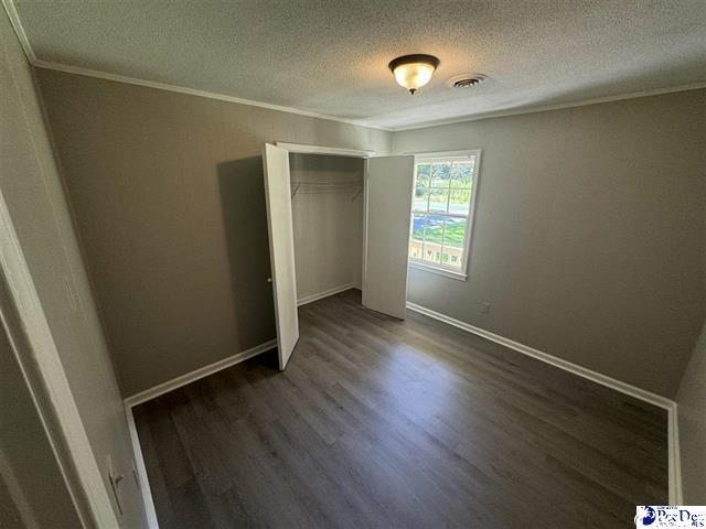 1057 Sam Lee Road Scranton, SC 29591 - Photo 17 of 23 Unfurnished bedroom featuring dark hardwood / wood