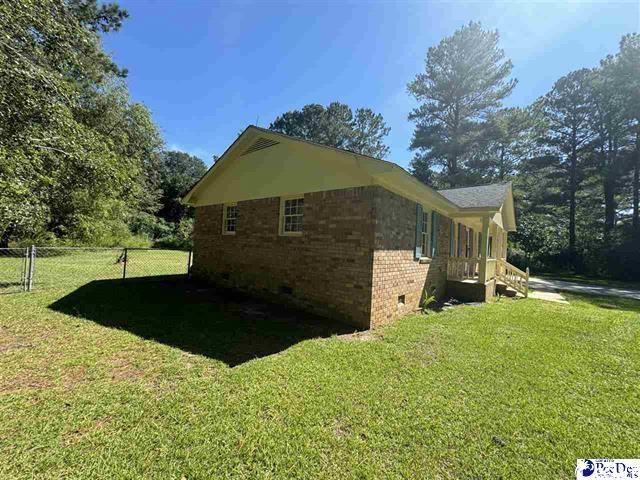 1057 Sam Lee Road Scranton, SC 29591 - Photo 8 of 23 View of side of property with a lawn