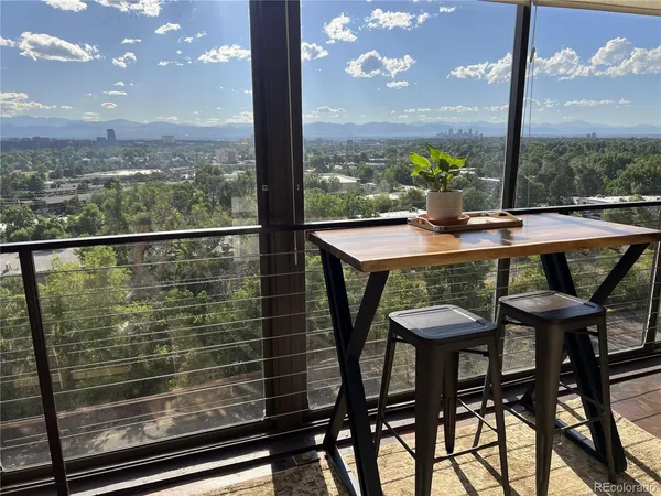 a view of a outdoor kitchen with a table and chairs