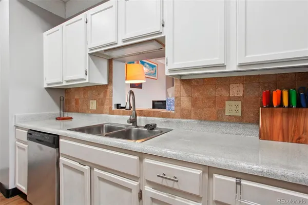a kitchen with stainless steel appliances granite countertop a sink and stove