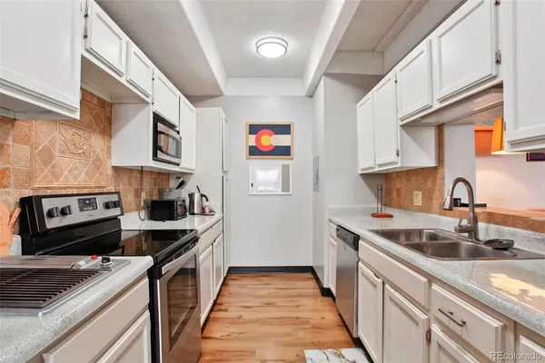 a spacious bedroom with a bed and a flat screen tv