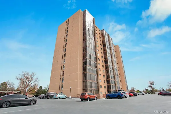 a view of a tall building next to a road