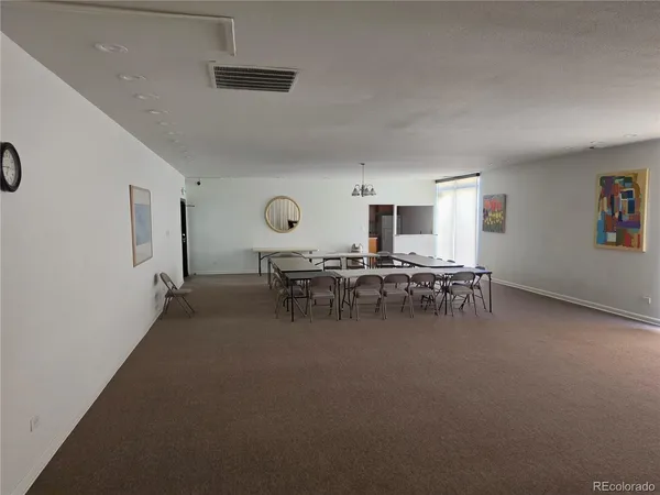 a view of a patio with table and chairs
