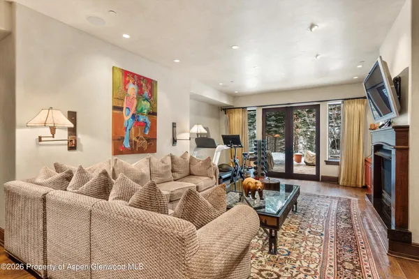 a living room with furniture a flat screen tv and a fireplace