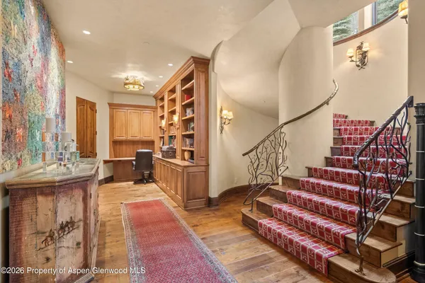 a bedroom with a balcony a bed and a fireplace