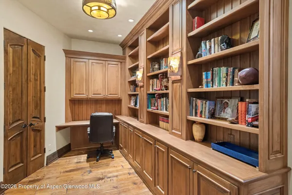 a bedroom with a bed couch and a large window