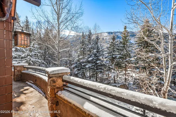 a living room with furniture a chandelier and a large window