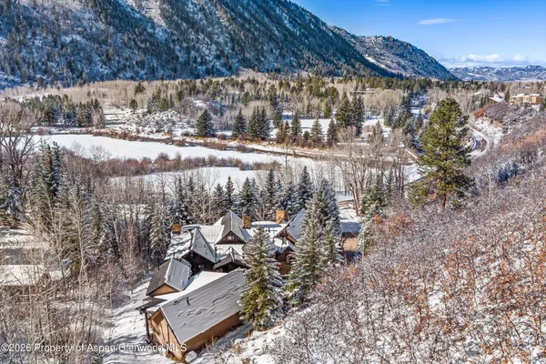 a spacious bedroom with a bed couch and a large window
